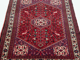 Low-angle view of a vintage Abadeh rug, showcasing its stepped medallion and intricate field.