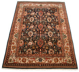 Corner of vintage Agra rug with complex arabesque border on beige ground, navy floral field.