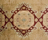 A geometric medallion with pinwheel florals in wine red, beige, and sky blue on a vintage Bulgarian carpet.