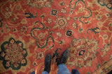 Detailed view of the vintage Agra carpet's full pile and oversized medallions in copper and blue.