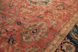 Close-up of traditional oversized medallions on the copper-toned field of a vintage Agra carpet.