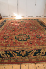 Angled perspective showing the full length of a vintage Agra carpet on a wood floor.