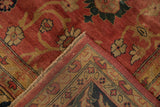 Corner of a vintage Agra carpet folded to show its plush pile and hand-knotted construction.
