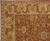 Detail of the Agra carpet's wide, Safavid-inspired border in wheat and copper with palmette motifs.