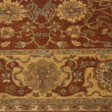 Close-up of the Agra carpet's wide Safavid border and copper field with scrolling vinery.