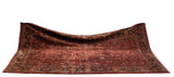 Draped vintage American Sarouk carpet highlighting its plush ruby red pile and intricate navy blue border.