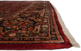 Full, lush pile and intact ruby red side cord selvage of a vintage American Sarouk carpet.