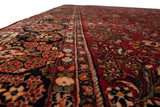 Close view of the vintage Sarouk's full, dense pile and detailed floral border.
