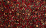 Detailed view of floral bouquets with sapphire blue accents on a vintage American Sarouk carpet.