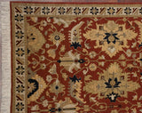 Narrow banded border beside a terracotta field with scrolling leaves and floral motifs.