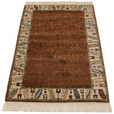 Vintage Armenian rug corner: colorful serrated leaf border, denim blue, sand motifs, ivory fringe.