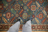 Plush wool pile of a vintage Armenian runner with terracotta, gold, and green floral motifs.