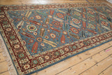 Angled view of the vintage Armenian runner's intricate paneled field design.