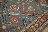 Angled detail of a vintage Armenian runner showing small animal and weaver insignia motifs.
