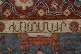 Close-up of the weaver's insignia woven into a cream border on a vintage Armenian rug.