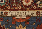 Hand-knotted weaver's insignia set within an ivory band on a vintage Armenian rug runner.