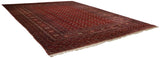 Perspective view of a hand-knotted Bokhara rug showing its impressive scale and lustrous red pile.