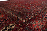 The lustrous, silk-like wool pile and intricate geometric borders of a vintage Bokhara-style carpet.