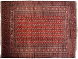 Vintage Bokhara rug with precisely aligned gul medallions on a rich, black cherry red field.