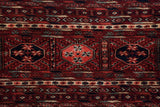 Finely knotted wool pile with traditional 'elephant's footprint' guls in navy blue and cherry red.
