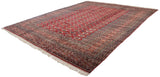 Plush pile, intricate geometric borders, and ivory fringe on a vintage Bokhara carpet.