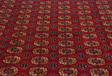 Detailed perspective of the tight, fine weave and repeating gul medallions on a vintage Bokhara carpet.