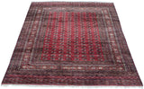 Vintage Bokhara rug corner displaying cherry red gul medallions and intricate multi-banded borders.