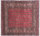 Vintage Bokhara rug corner with cherry red gul medallions and intricate geometric borders.