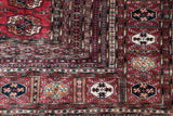 Vintage Bokhara rug corner with cherry red gul medallions and fine geometric borders.