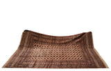 Vintage Bokhara carpet draped to show its lustrous wool pile and geometric gul medallions.