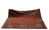 Vintage Bokhara carpet draped to show the high sheen and luster of its plush wool pile.