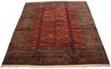 Angled view of a vintage Bokhara carpet highlighting the lustrous sheen across its traditional gul design.