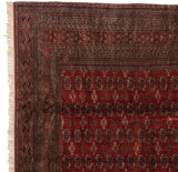 Corner detail showing the intricate geometric border and intact side selvage of a fine Bokhara carpet.