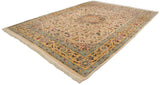 Angled perspective on a vintage Isfahan carpet, revealing the full ivory field and saffron border.