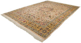 Angled view of a vintage Isfahan carpet's saffron border with bird motifs and full ivory pile.