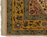 Pictorial birds and floral motifs on the saffron and blue border of a vintage Isfahan design carpet.