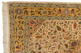 Saffron yellow border with intricate bird and blossom details on a vintage Isfahan design carpet corner.