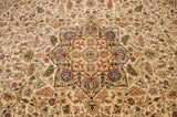 Detailed starburst medallion with delicate vinery in shades of blue and fuchsia on an ivory carpet.