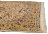 Intricate bird and floral motifs in the saffron border of a vintage Bulgarian Isfahan design carpet.