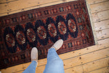 Plush vintage Bokhara runner with lustrous, tight weave gul medallions in navy and rust.
