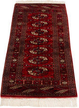 Fine weave with detailed gul medallions and intricate borders on the cherry red Bokhara runner.