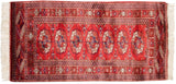 Fine cherry red Bokhara runner, showing detailed geometric gul medallions and ivory fringe.