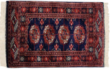 Vintage Bokhara rug mat displaying a classic gul pattern with a plush, high-sheen wool pile.