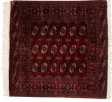 Finely woven gul medallions in wine red, deep rust, and navy on a vintage Bokhara rug.