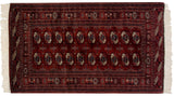 The repeating multi-column design of gul medallions on a fine vintage Bokhara rug.