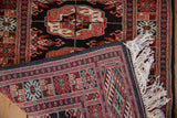 Intact side cord selvage and ivory fringe on a hand-knotted vintage Bokhara rug mat.