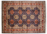 Overhead view showing the intricate geometric pattern and lustrous pile of a vintage Caucasian design carpet.