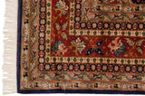 Delicate vinery and blossoms in the rust and indigo borders of a vintage Pakistani rug.
