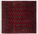 Fine Bokhara square carpet in cherry red with repeating gul medallions detailed in navy and ivory.