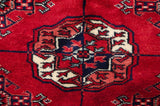Finely knotted gul medallion with a plush, high-sheen wool pile in red and navy.